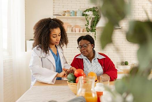 In home Nursing with a patient in a red sweater in Alpharetta