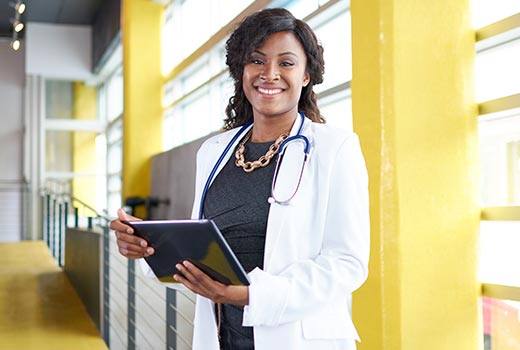 a woman doctor holding a tablet in a Home Health Agency in Marietta, Atlanta, Alpharetta, Douglasville, DeKalb County