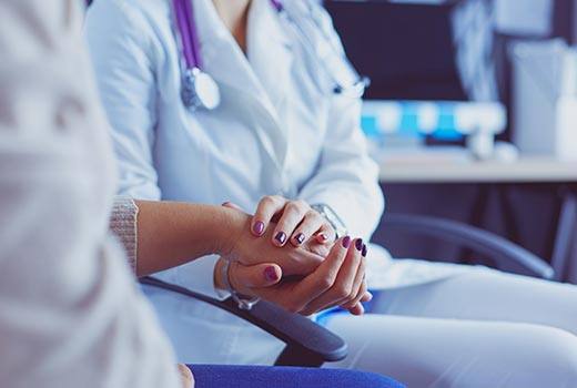 Doctor holding woman's hand after catastrophic injury care in Marietta, GA