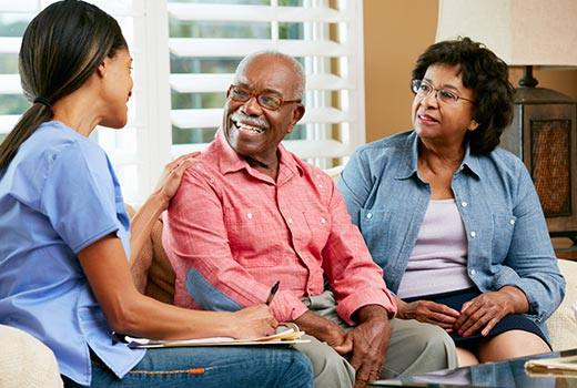 Certified Nursing Assistant speaking with elderly couple in Douglasville, GA